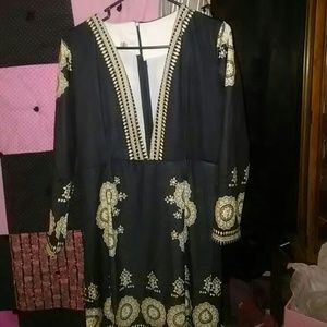 Low cut black and tan dress with pattern.